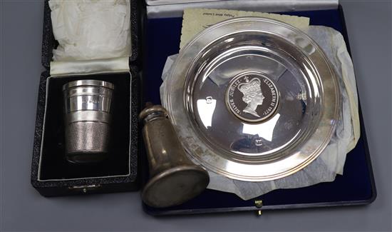 A Queen Elizabeth II silver medallion dish, a silver pepper and silver just a thimbleful cup.